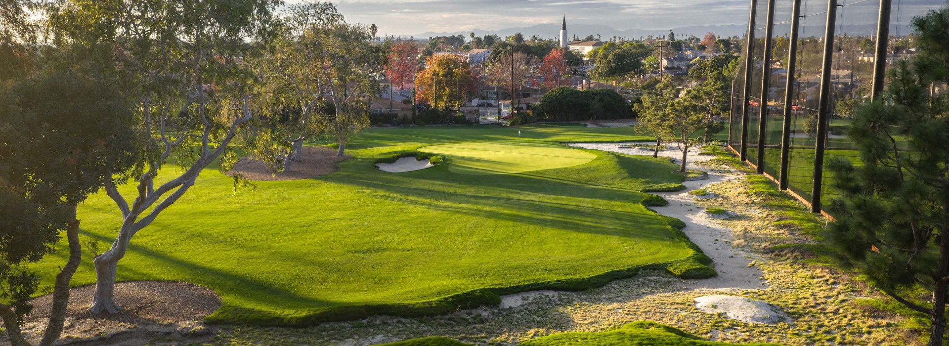 Image of golf ball on tee on grass.